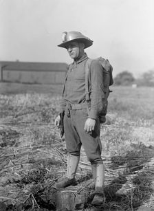 Leonard D.Mahon with Steel Helmet He Invented That Could Be Used As Shovel, 1917. Creator: Harris & Ewing