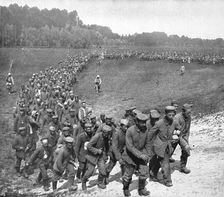 Les "Douceurs" de la captivite; convoi de prisonniers en marche vers la gare..., 1916 (1924) Creator: Unknown