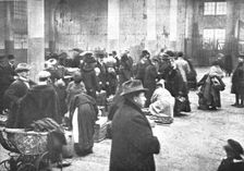 Les Indesirables; Au marche couvert de Mulhouse: la verification des bagages par..., 1918. Creator: Unknown
