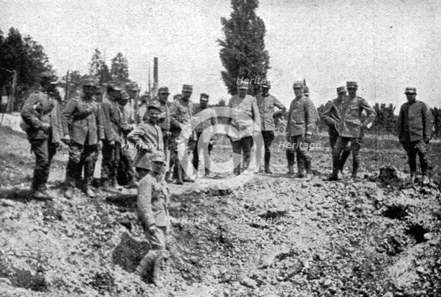 'les premieres operations Italiennes; le premier entonnoir creuse par un 305 autrichien', 1915. Creator: Unknown.