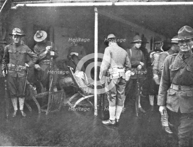'Les Premiers Contingents Americains en France; A bord d'un transport: soldats se preparent..., 1917 Creator: Unknown.