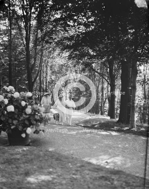 Leslie, Margeurite, and unidentified couple, walking in the woods, 1917 Aug. 18. Creator: Arnold Genthe.