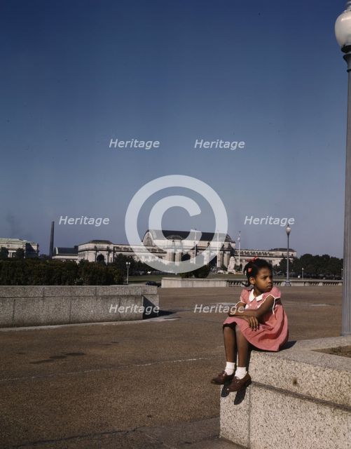 Little girl in a park with Union Station in the background, Washington, D.C., ca. 1943. Creator: Unknown.