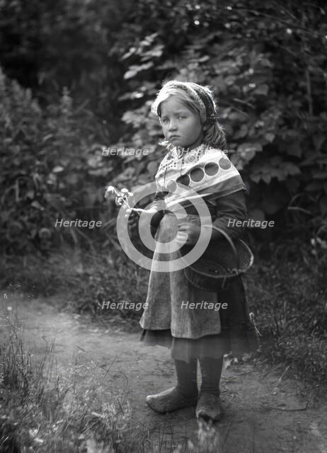 Little girl with basket and flowers in hands, 1898-1900.  Creator: Johan Severin Nilson.