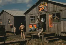 Living quarters and "juke joint" for migratory workers, a slack season; Belle Glade, Fla., 1941. Creator: Marion Post Wolcott