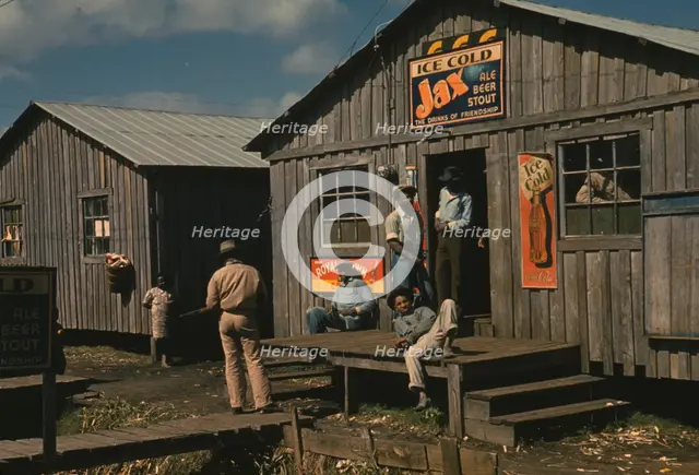 Living quarters and "juke joint" for migratory workers, a slack season; Belle Glade, Fla., 1941. Creator: Marion Post Wolcott.