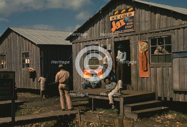 Living quarters and "juke joint" for migratory workers, a slack season; Belle Glade, Fla., 1941. Creator: Marion Post Wolcott.
