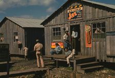 Living quarters and "juke joint" for migratory workers, a slack season; Belle Glade, Fla., 1941. Creator: Marion Post Wolcott