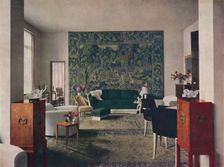 Living-room designed by Porteneuve & Dominique, the end wall of which is hung with an old tapestry