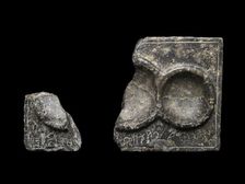 Libation table fragment; corner and part of two circular receptacles, c2325-c2175BC.