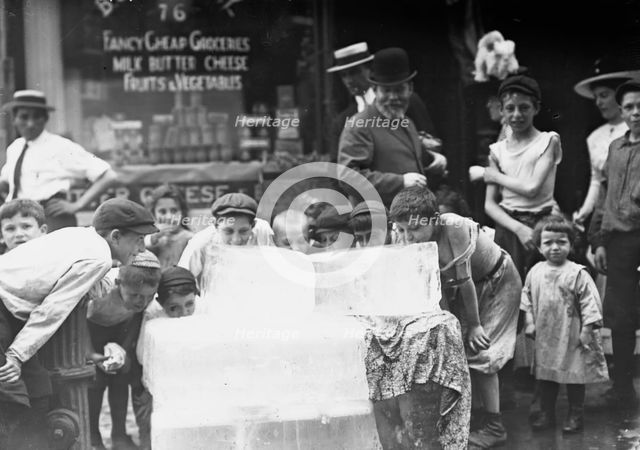 Licking blocks of ice on hot day, between c1910 and c1915. Creator: Bain News Service.