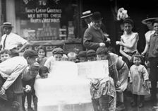 Licking blocks of ice on hot day, between c1910 and c1915. Creator: Bain News Service