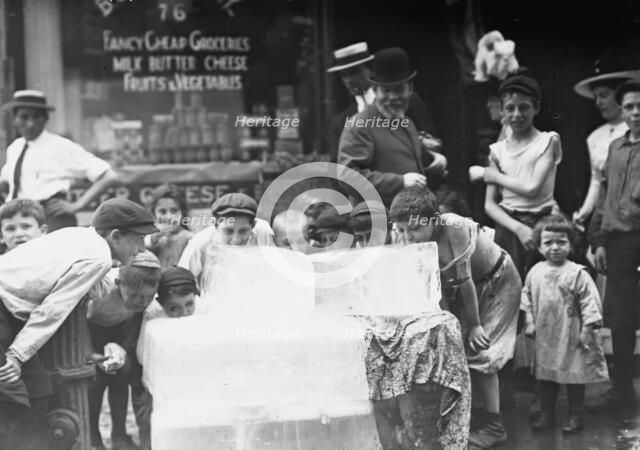 Licking blocks of ice on hot day, between c1910 and c1915. Creator: Bain News Service.