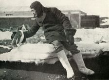 Lieut. Rennick and a Friendly Penguin 1911, (1913). Artist: Herbert Ponting