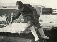Lieut. Rennick and a Friendly Penguin 1911, (1913). Artist: Herbert Ponting