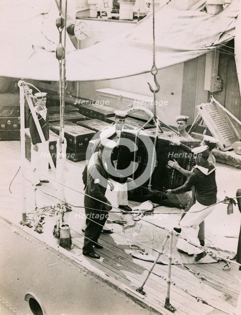 Lifting a case from the deck of  H.M.S. Suffolk at Portsmouth, July 1935. Creator: Topical Press Agency.