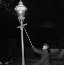 Lighting a gas lantern. Landskrona, Sweden, 1956