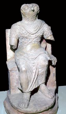 Limestone seated figure of Horus wearing Roman military costume, Egyptian