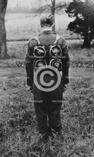 Limpet mines being carried on a harness on the back of a soldier, c1943. Creator: British Government.