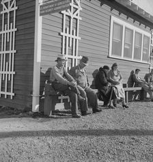 Lineup outside of Farm Security Administration grant office early in the morning, Tulare, CA, 1938. Creator: Dorothea Lange