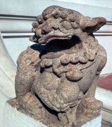 Lion guardian on the steps of a Buddhist temple