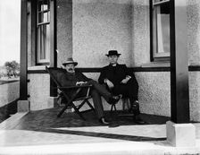 Lloyd George resting on the verandah of a house