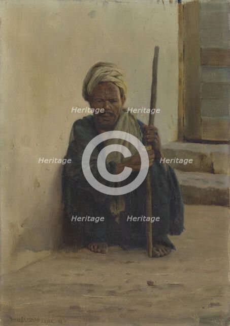 Luxor, Arab holding a stick sitting in a street, 1892. Creator: Henry Brokman.