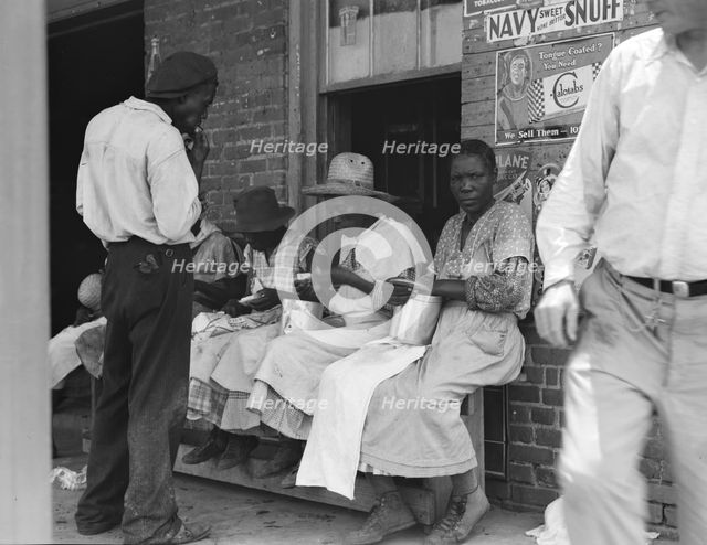 Lunchtime for these Georgia peach pickers, Muscella, Georgia, 1936. Creator: Dorothea Lange.