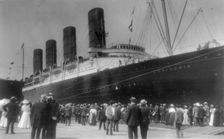LUSITANIA arriving in N.Y. for first time, Sept. 13, 1907: starboard view; crowd at dock..., 1907. Creator: Frances Benjamin Johnston