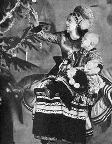 Mother and child with Christmas tree, Matyo people, Miskole, Hungary, 1936