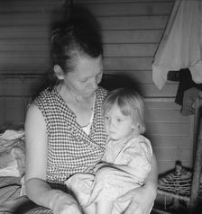 Mother from Oklahoma, awaits visit of resident nurse for sick baby, FSA camp, Farmersville, CA, 1939 Creator: Dorothea Lange