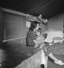 Mother with sick baby awaits arrival of FSA camp resident nurse, Tulare County, CA, 1939. Creator: Dorothea Lange