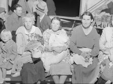 Mothers on the sidelines watch the Halloween party at Shafter migrant camp, California, 1938. Creator: Dorothea Lange