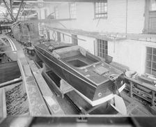 Motor launch in boatyard shed, 1913. Creator: Kirk & Sons of Cowes