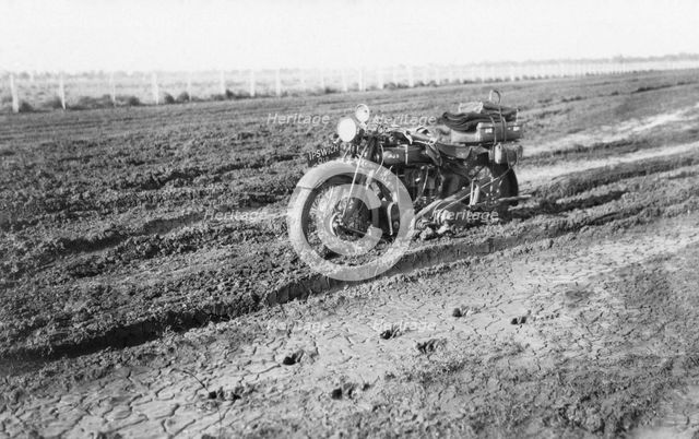 Motorbike in mud, near Dalby, Queensland, 1930. Creator: Jack Bain.