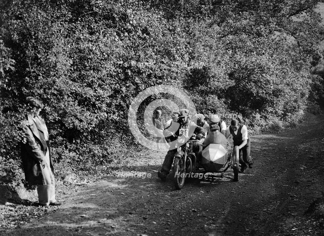 Motorcycle and sidecar competing in the Brighton and Hove Motor Club Brighton-Beer Trial, 1930. Artist: Bill Brunell.