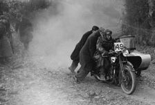Motorcycle and sidecar receiving a push during a trial, c1930s. Artist: Bill Brunell