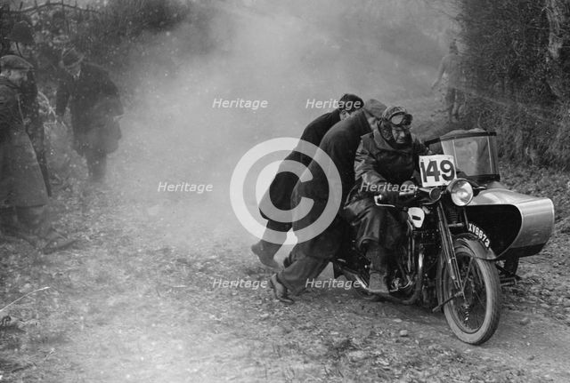 Motorcycle and sidecar receiving a push during a trial, c1930s. Artist: Bill Brunell.
