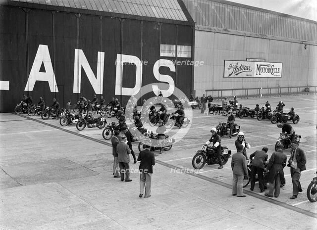 Motorcycles on the start line at the MCC Members Meeting, Brooklands, 10 September 1938. Artist: Bill Brunell.