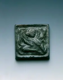 Mottled black jade square belt plaque with drummer in relief, Tang dynasty, China, 618-907. Creator: Unknown
