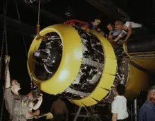 Mounting motor on a Fairfax B-25 bomber, North American Aviation, Inc., Inglewood, Calif., 1942. Creator: Alfred T Palmer