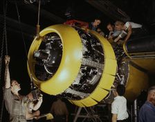 Mounting motor on a Fairfax B-25 bomber, North American Aviation, Inc., Inglewood, Calif., 1942. Creator: Alfred T Palmer