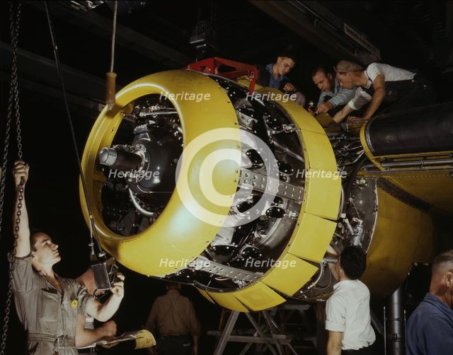 Mounting motor on a Fairfax B-25 bomber, North American Aviation, Inc., Inglewood, Calif., 1942. Creator: Alfred T Palmer.
