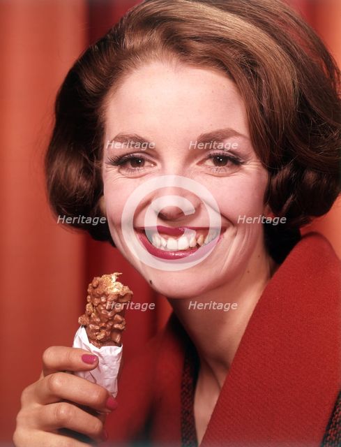 Model eating chocolate bar, c1955. Creator: Arthur Charles Kirby Ware.
