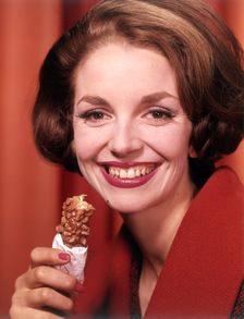 Model eating chocolate bar, c1955. Creator: Arthur Charles Kirby Ware