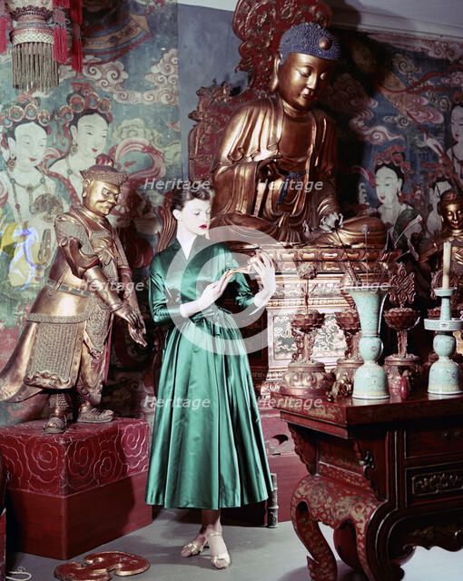 Model showing an evening dress in oriental style, 1950s.  Artist: Göran Algård