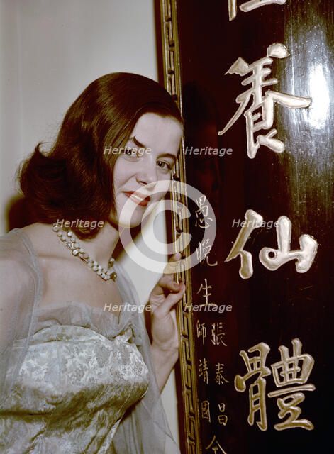 Model showing an evening dress in oriental style, 1950s.  Artist: Göran Algård