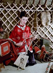 Model showing an evening jacket in oriental style, 1950s. Creator: Göran Algård