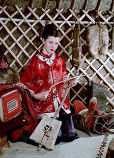 Model showing an evening jacket in oriental style, 1950s. Creator: Göran Algård