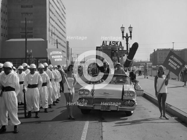 Models and a Cadillac on a parade, USA, (c1959?). Artist: Unknown